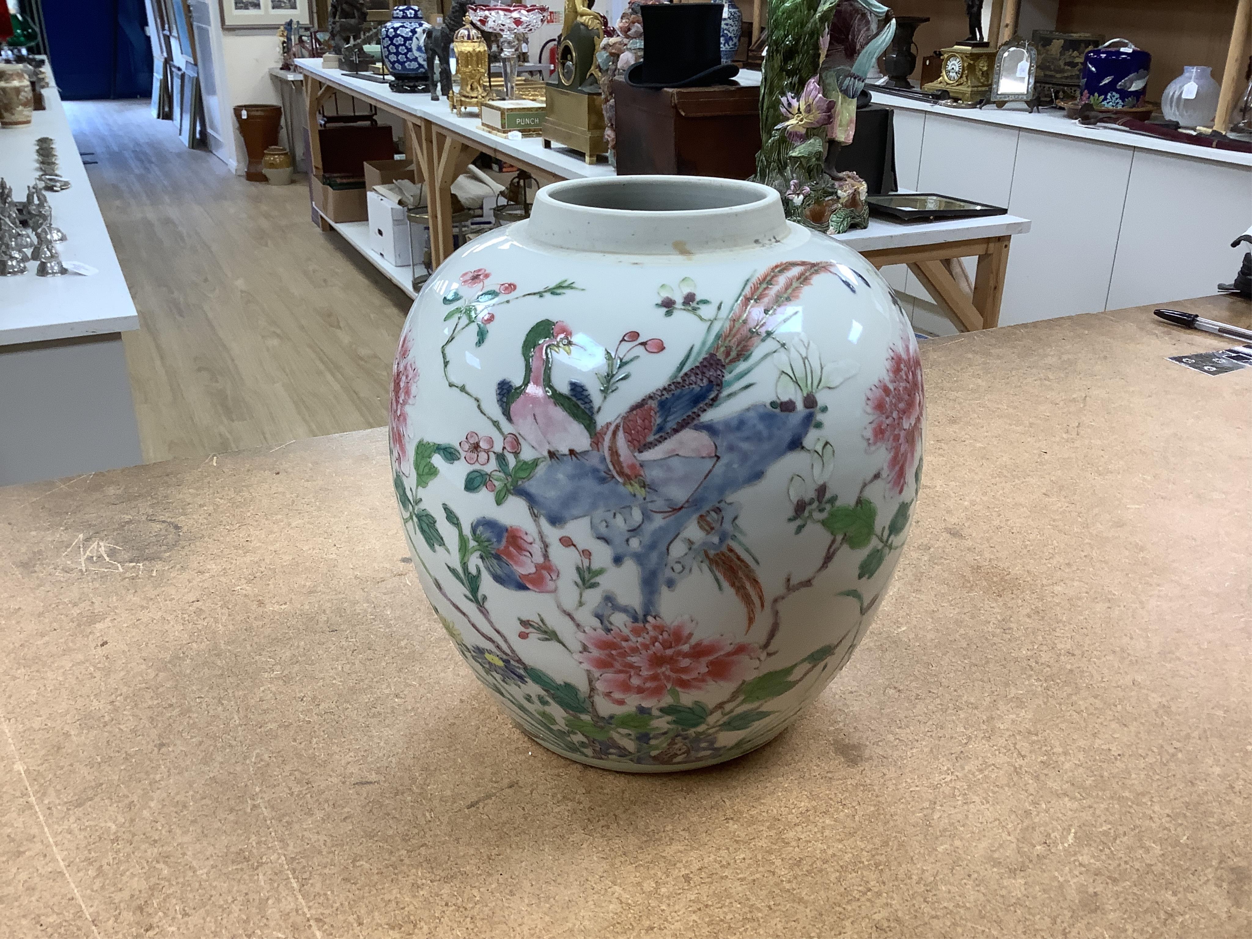 A late 19th century Chinese famille rose 'pheasant' jar lacking cover, with finely carved wooden stand, 21.5cm high including stand.